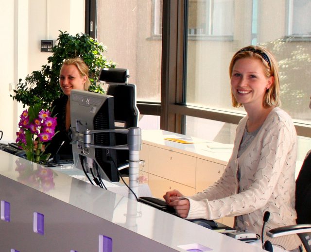 A young woman at her computer in reception