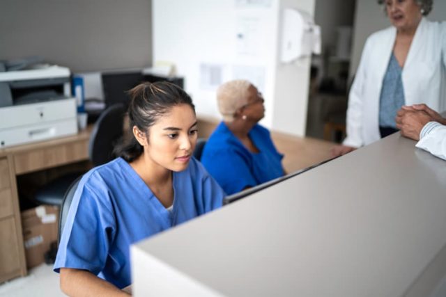 Medical assistant at a hospital working on computer