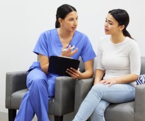 Medical assistant speaking with a patient