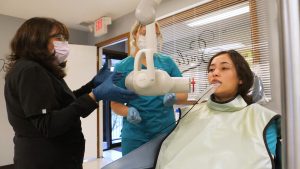 dental assisting students are training with dental equipment